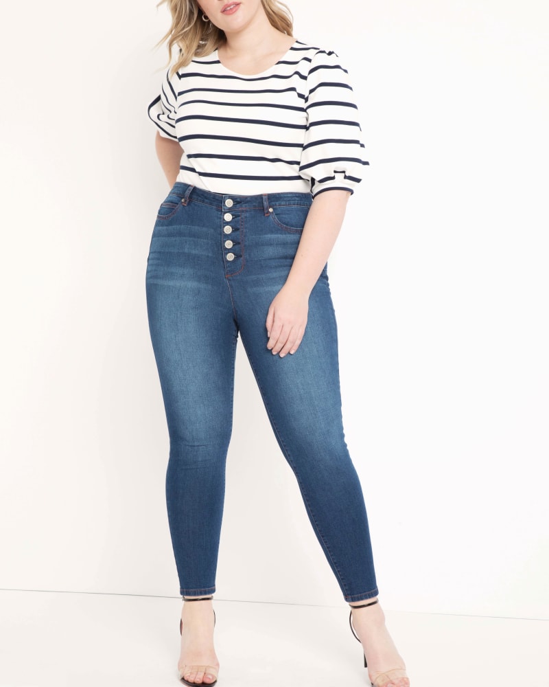 Front of a model wearing a size 14 Classic Fit Peach Lift Button Fly Skinny Jean in Dark Wash by ELOQUII. | dia_product_style_image_id:206706